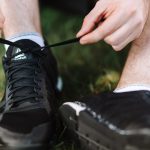 close up view of a person tying shoelace